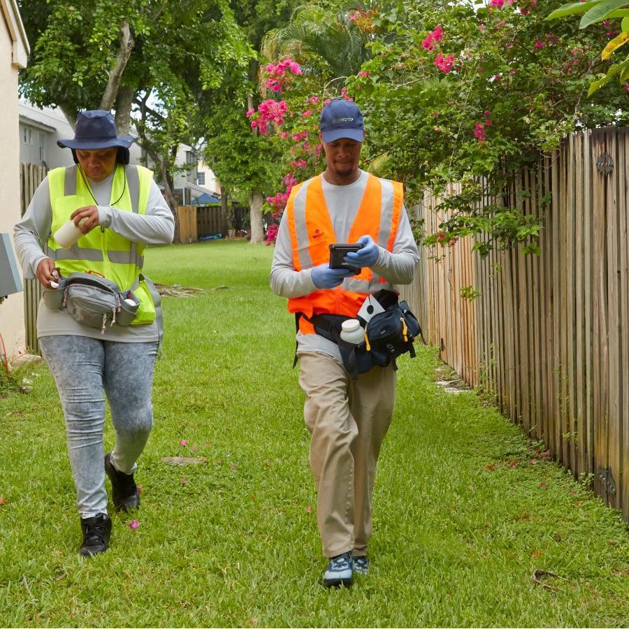 Two abatement workers in the field